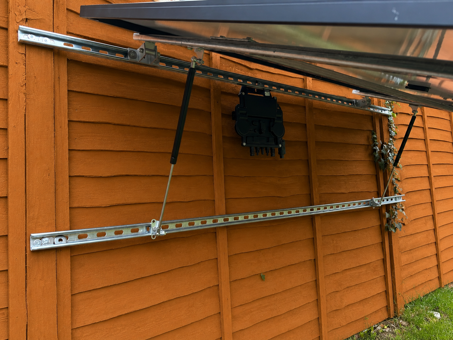 Microinverter mounted behind plug-in solar panel