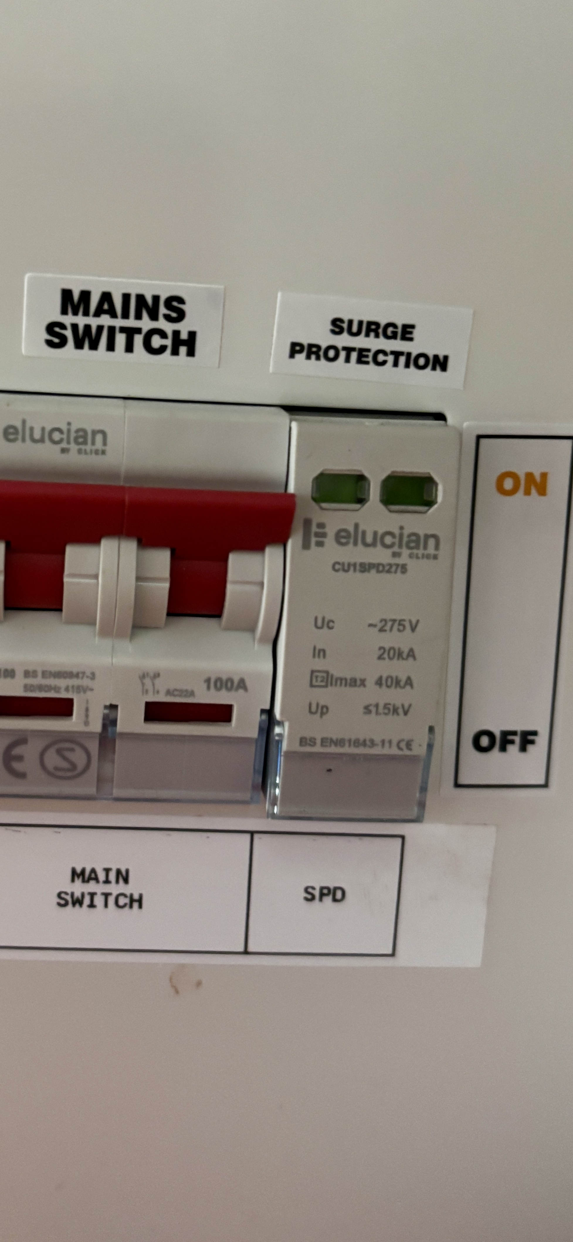 Type 2 surge protection device installed in a UK consumer unit beside the main switch